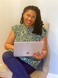 a woman sitting in a chair with a laptop